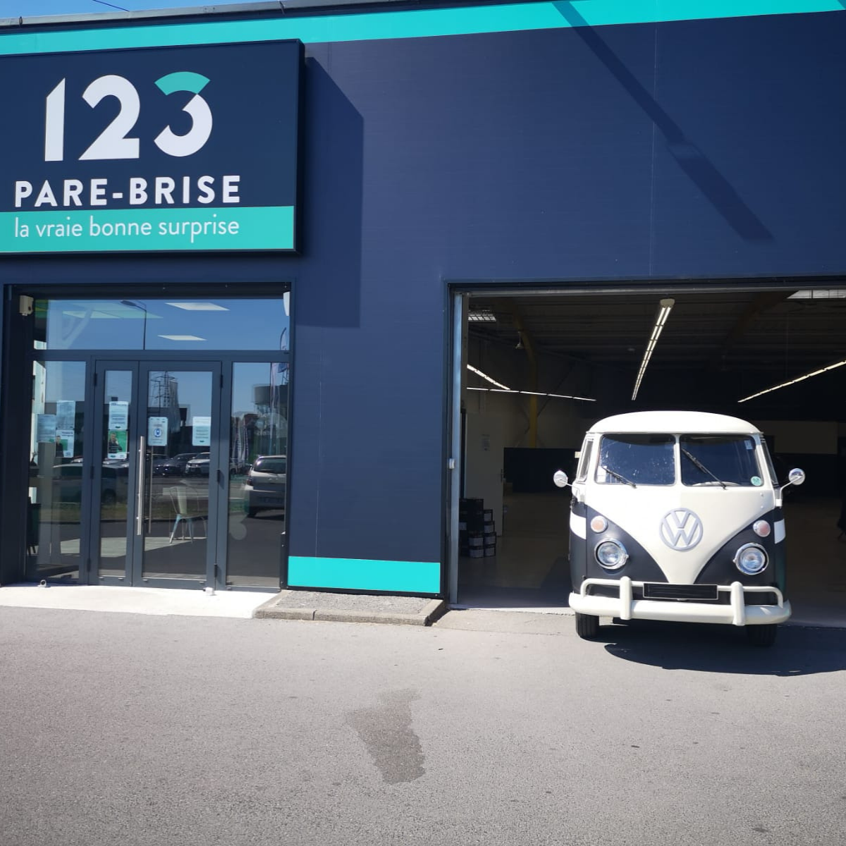Les logos des marques de voiture : Combi Van VW devant notre agence 123 Pare-Brise Villeneuve d'Ascq.